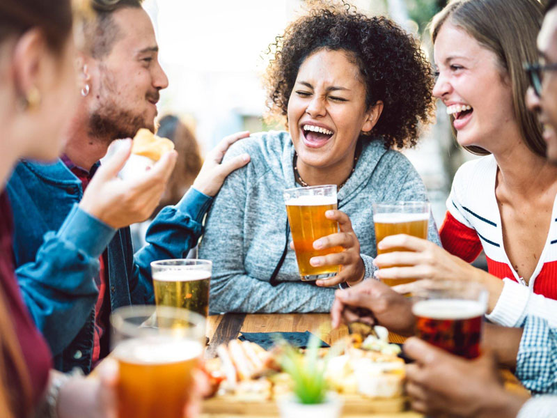 people eating and drinking beer